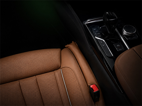 Leather seat gap filler closing the space between car seats